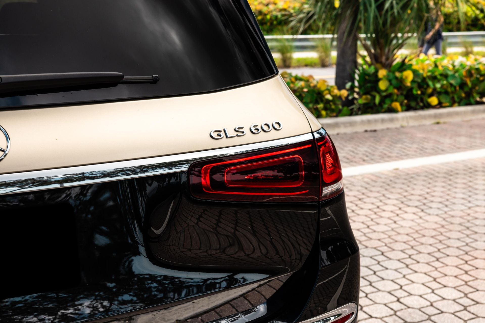 Mercedes-Benz GLS 600 car rear view with 'GLS 600' branding on a road.