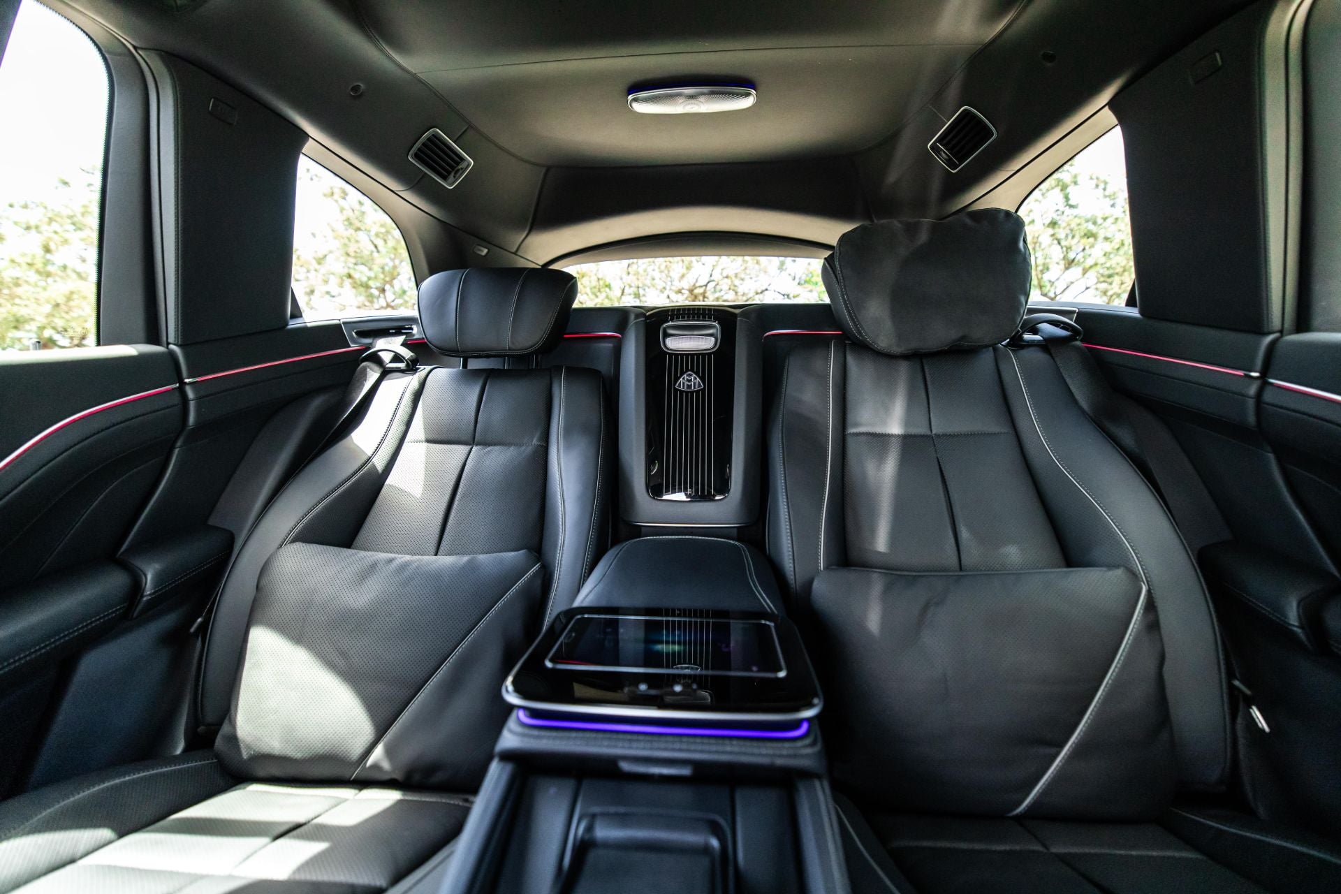 Mercedes Maybach GLS600 rear seat interior with black leather seats and a central console.